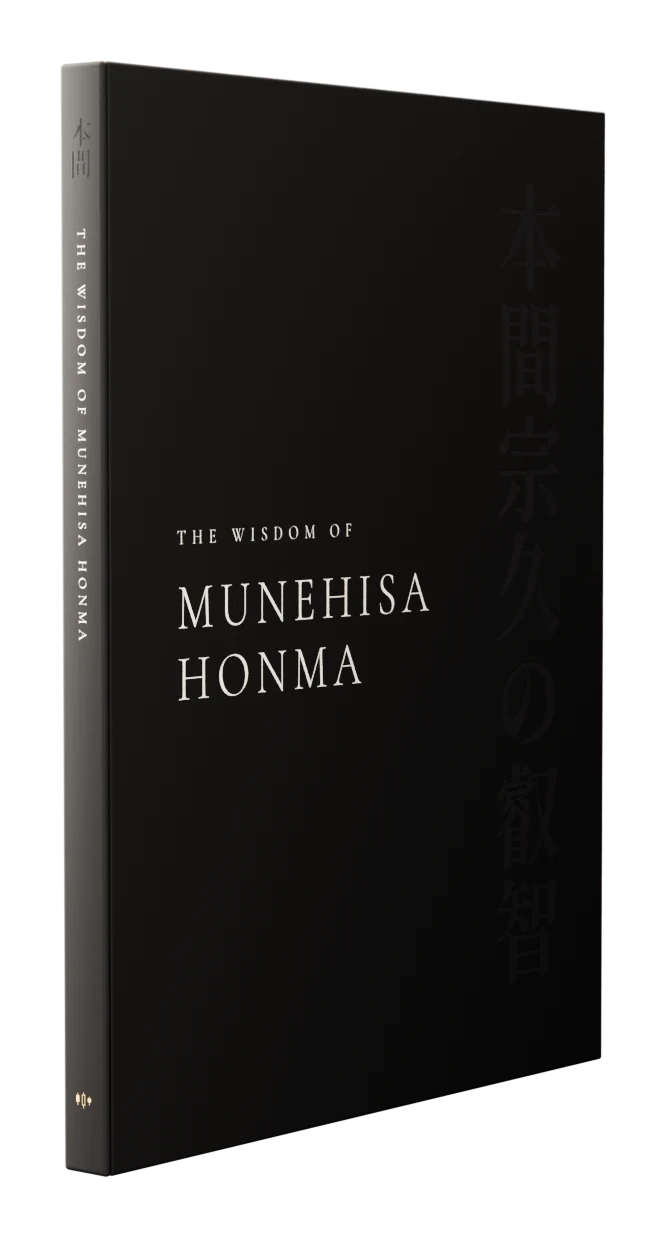 The hardcover edition of The Wisdom of Munehisa Honma: a black cover with the title in white capitals and 本間宗久の叡智 set vertically in gloss black